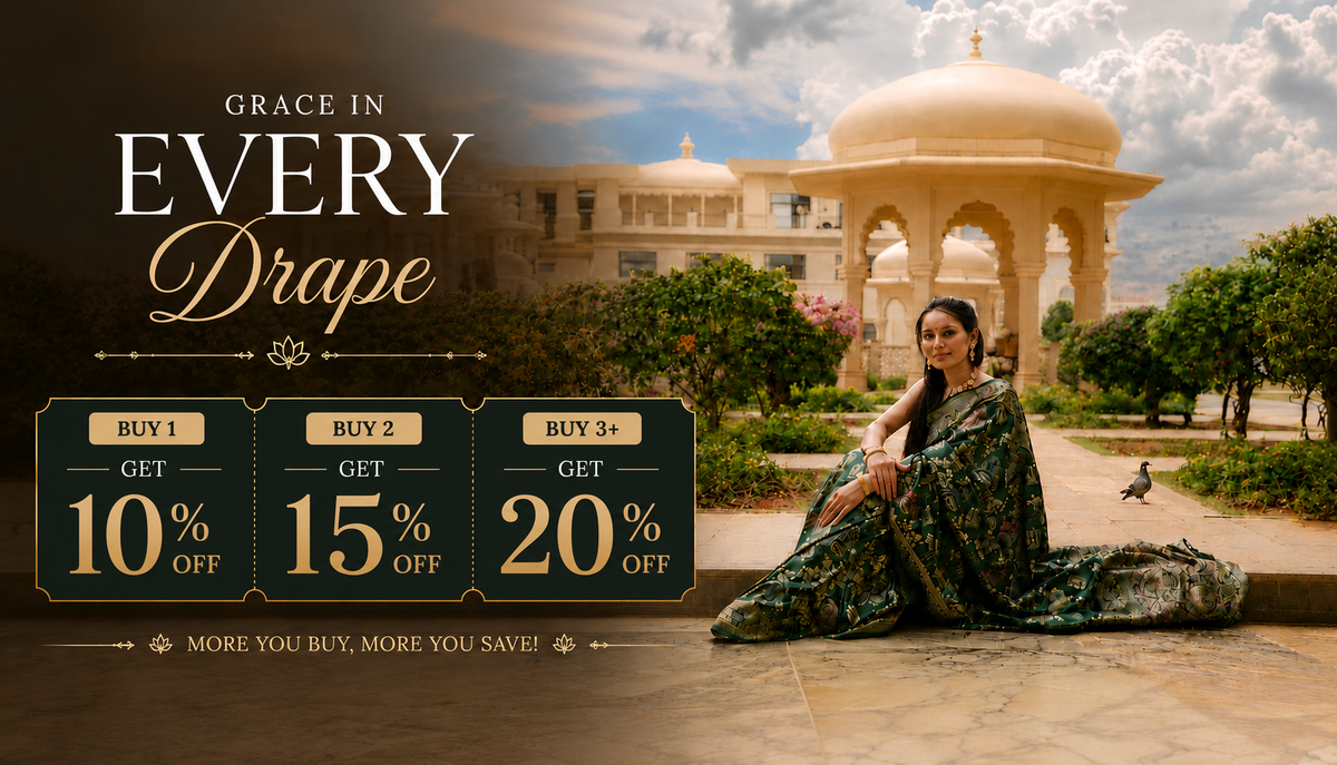 A woman in a dark green patterned sari sits on a stone pathway in front of a grand domed palace, with promotional text reading 'Grace in Every Drape' and discount offers for buying 1, 2, or 3 dresses.